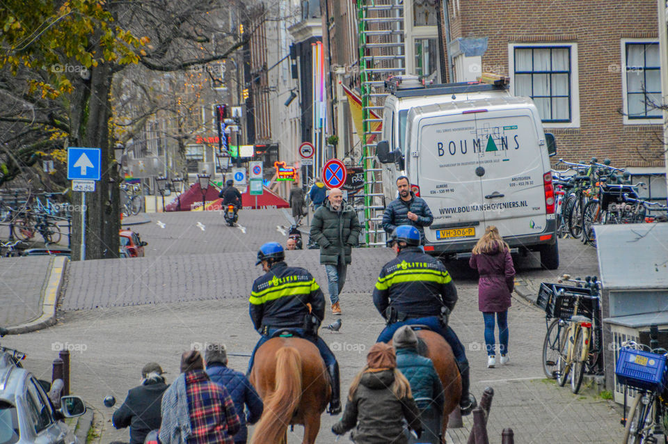 Policemen On Horses At Amsterdam The Netherlands