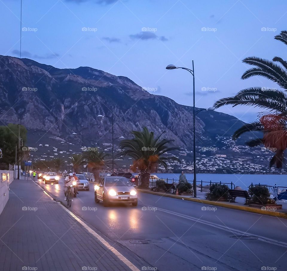 Cars on a road by the beach