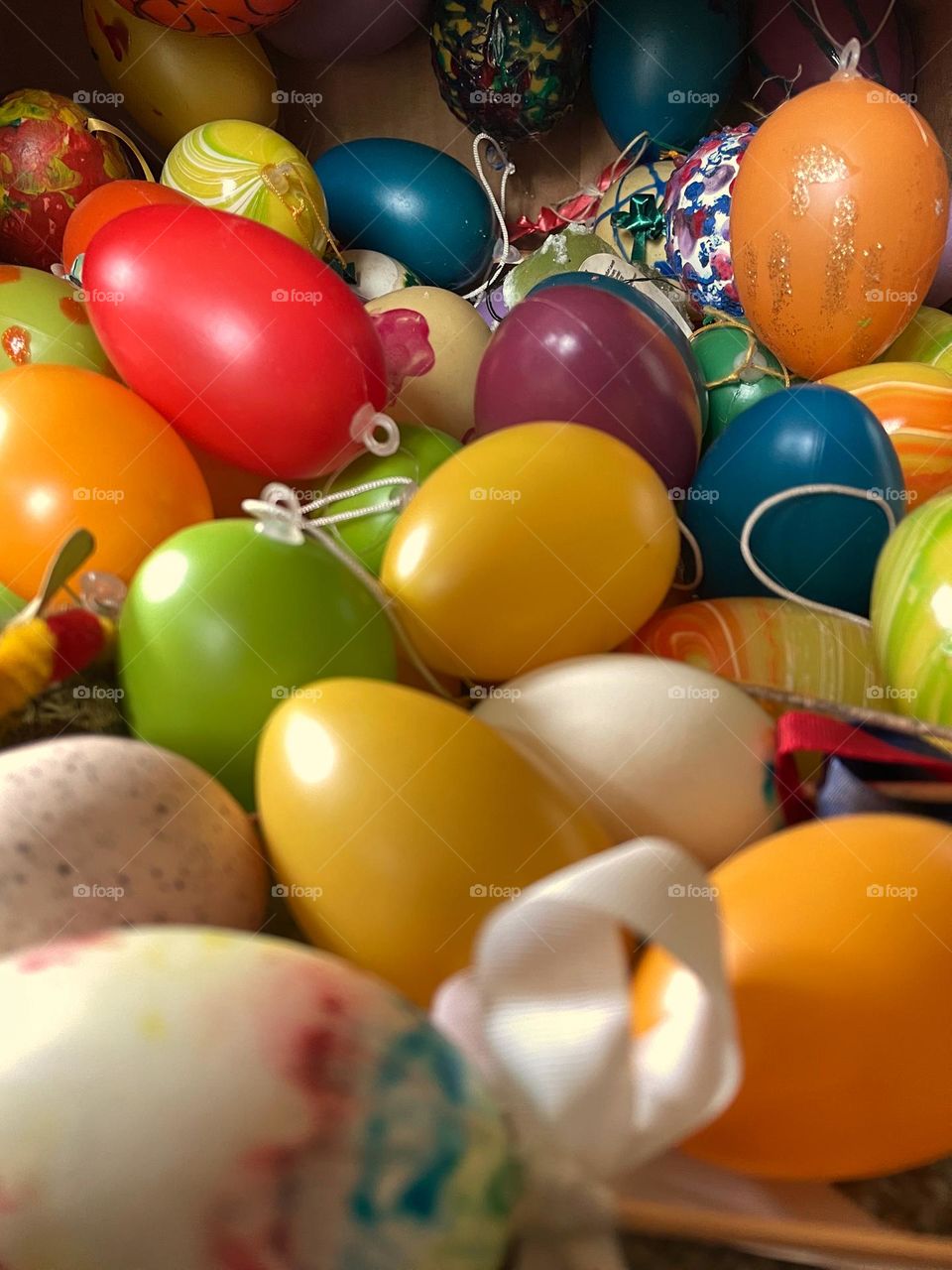 Close-up of many colorful Easter eggs in a box