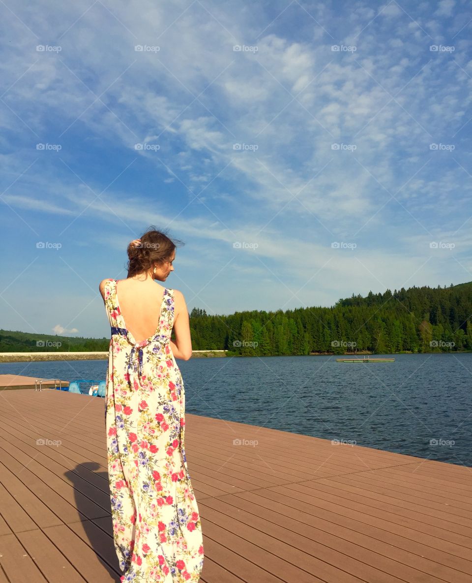 Young woman standing on pier
