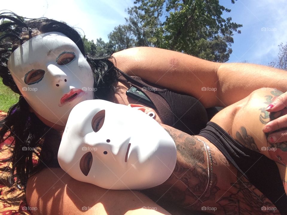 Couple in the park wearing masks