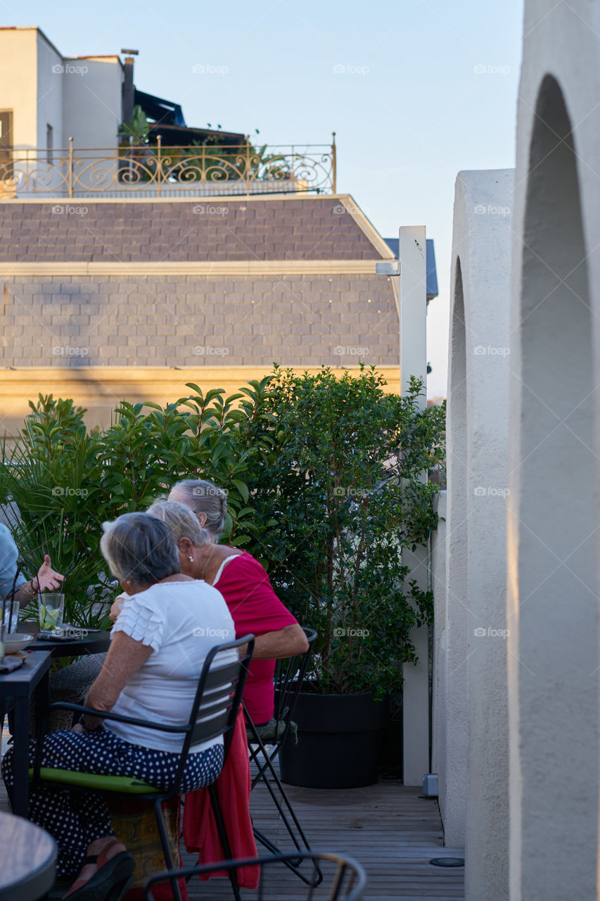 Elderly friends at a rooftop bar