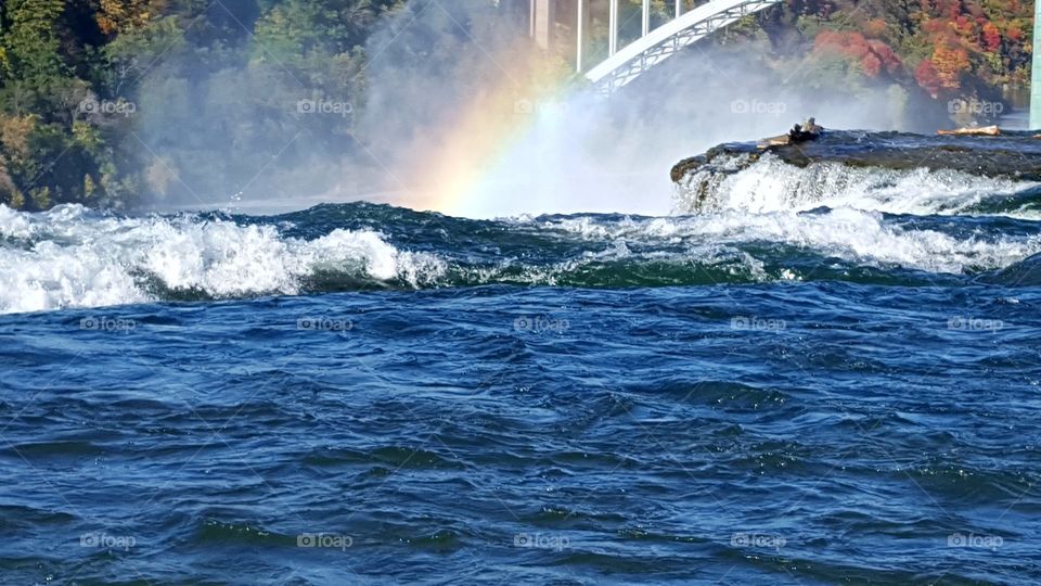 rainbow in waterfalls Canada and new york