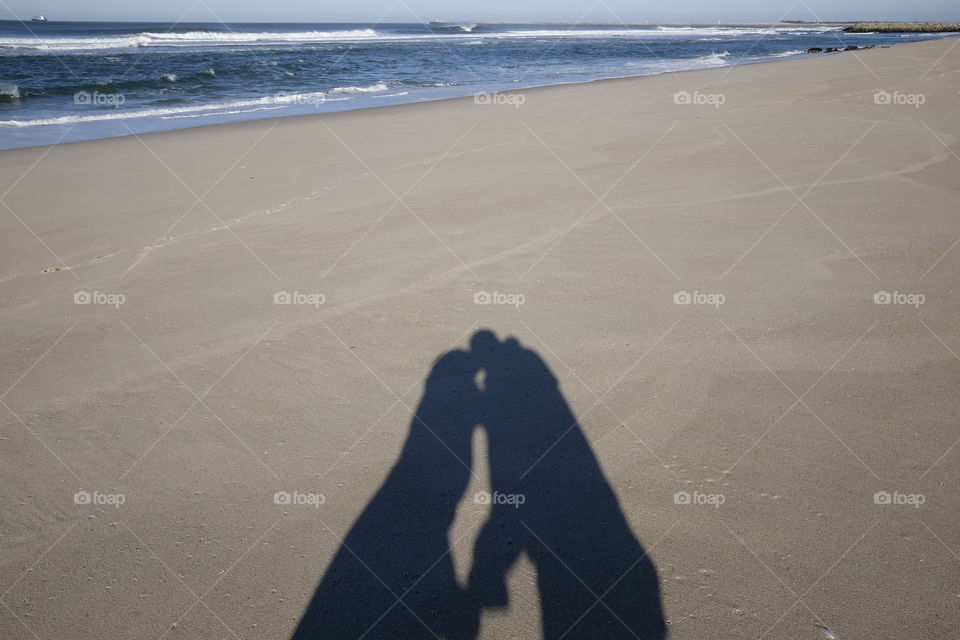 Shadows kiss in the ocean