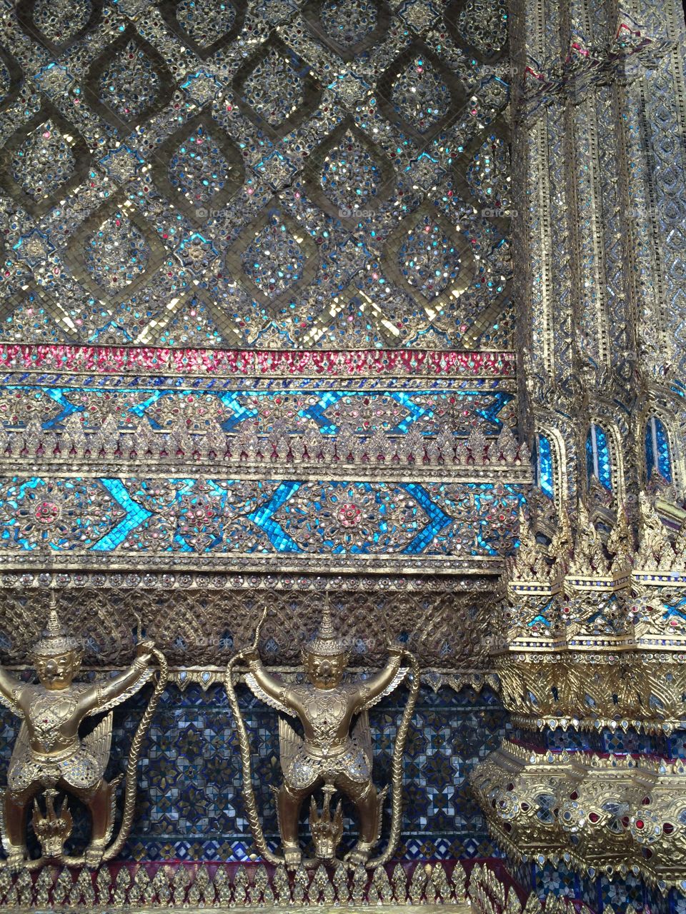 Bangkok, Thailand: Mosaic wall of the Grand Palace with gold Buddhas and jewel mosaic wall
