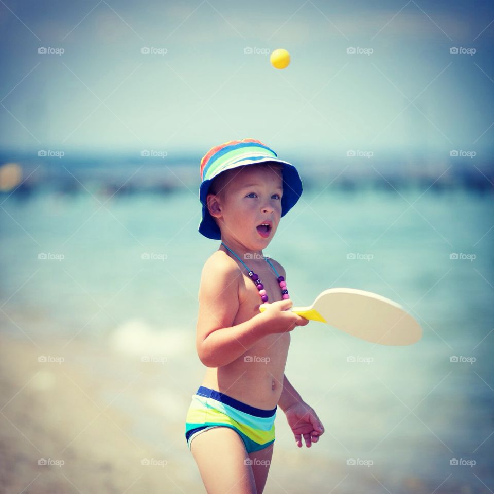 boy on the beach. little boy on the beach playing active sports