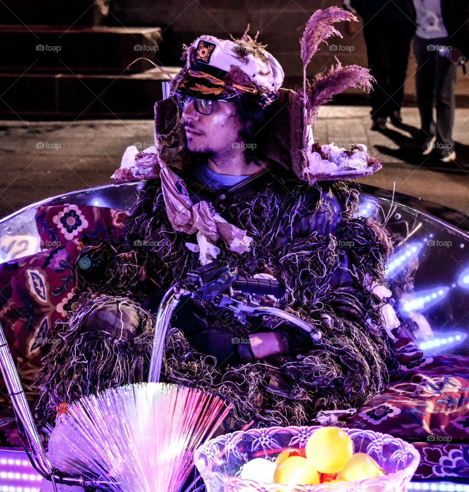 A character dressed I. Light and other garb entertains crowds at the light festival. 