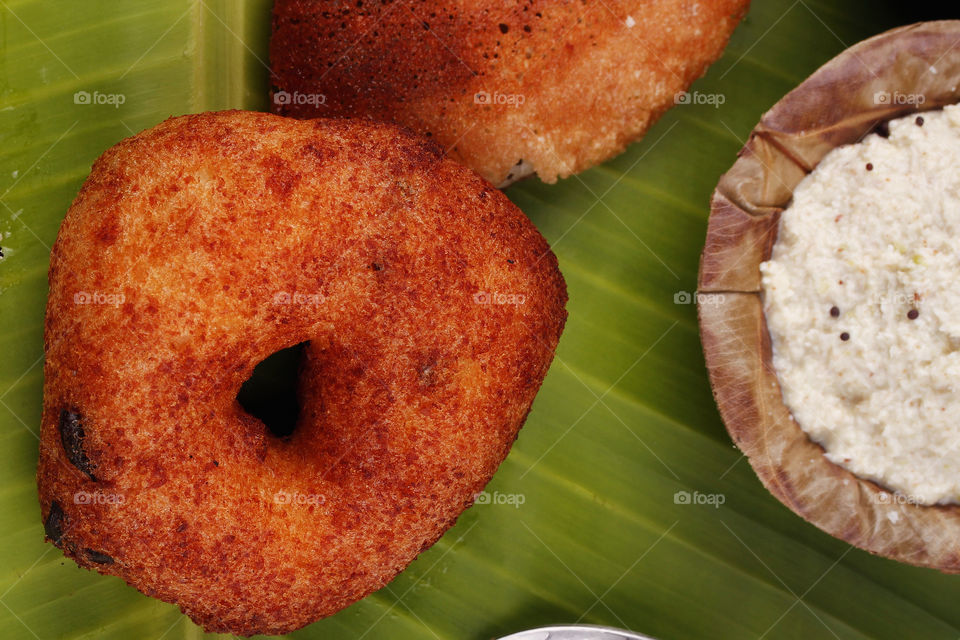 Vada, a Popular Indian snack served hot preferably on a banana leaf