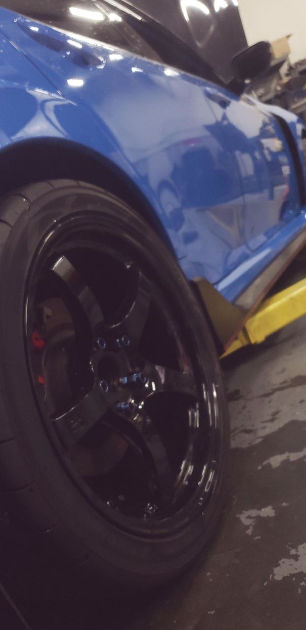 black wheel on blue honda