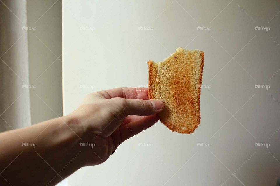 White bread fried toast in the hand