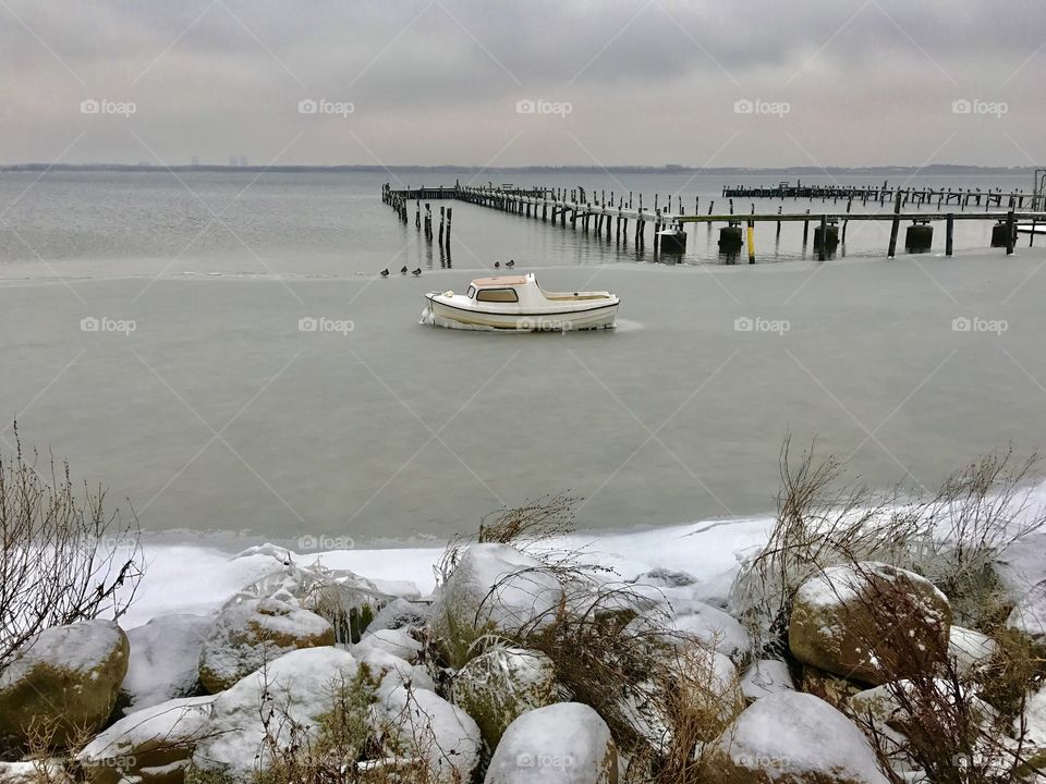 Boat in sea by pier