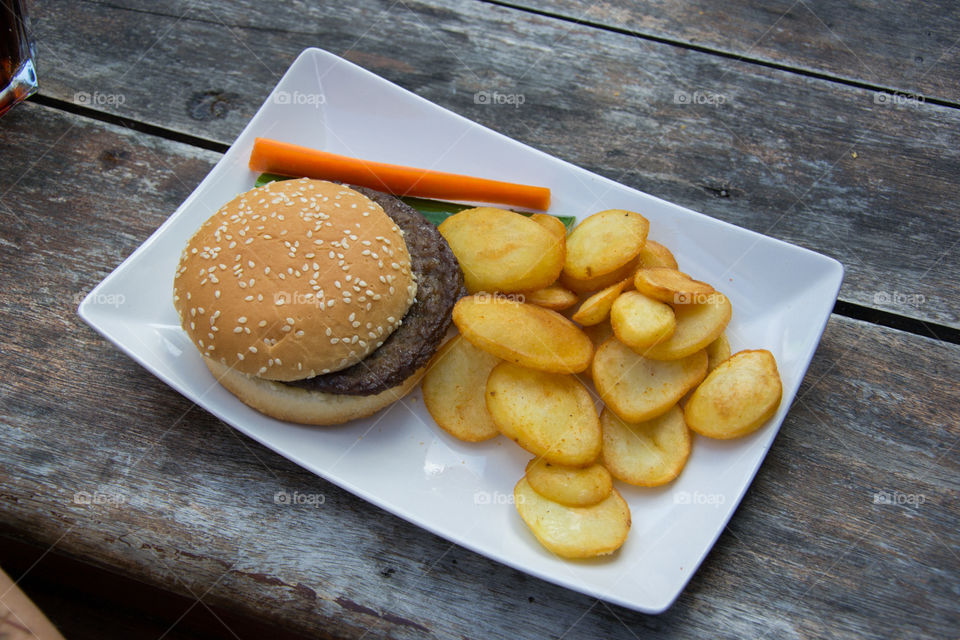 Hamburger with dollar fries at a restaurant in Halmstad Sweden.