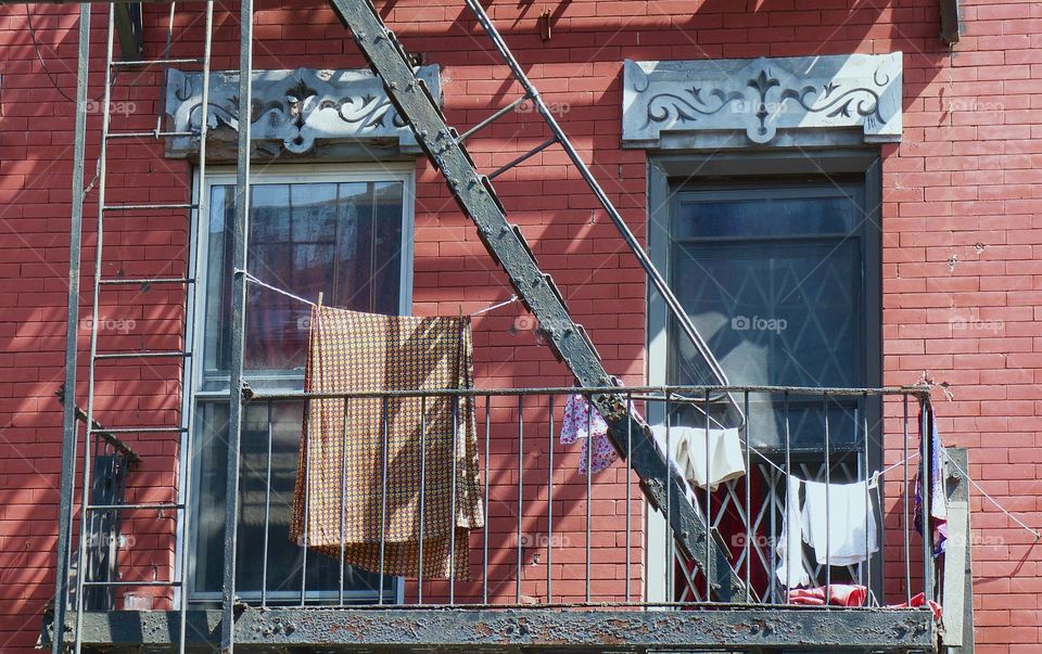 A fire escape building in Williamsburg, Brooklyn, New York City with family laundry being dried.
