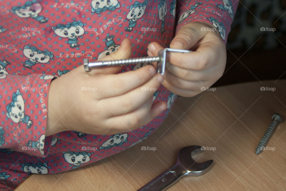 little girl holding tools