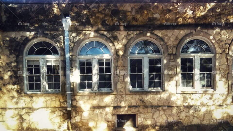 Old windows and limestone wall
