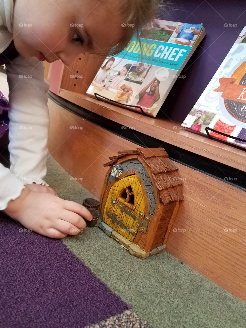 child visiting fairy house