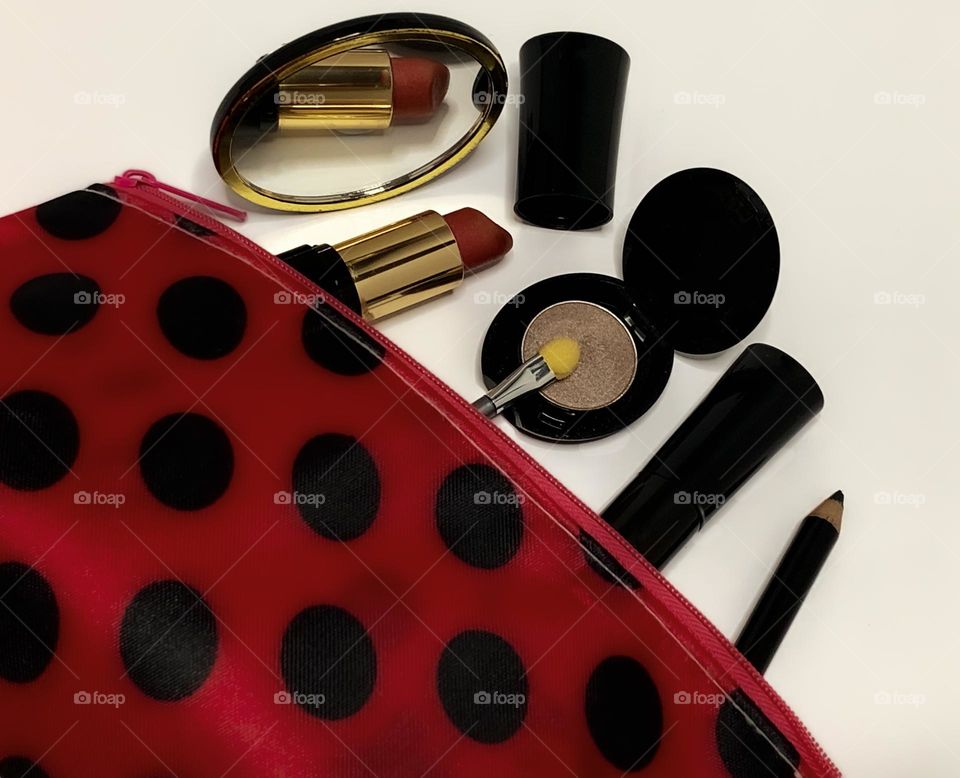 Red and black polka dot cosmetics bag, with unbranded, black cased make up & a mirror 