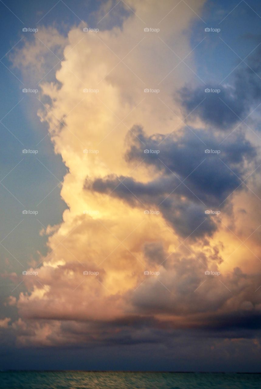 Storm cloud over the sea at sunset