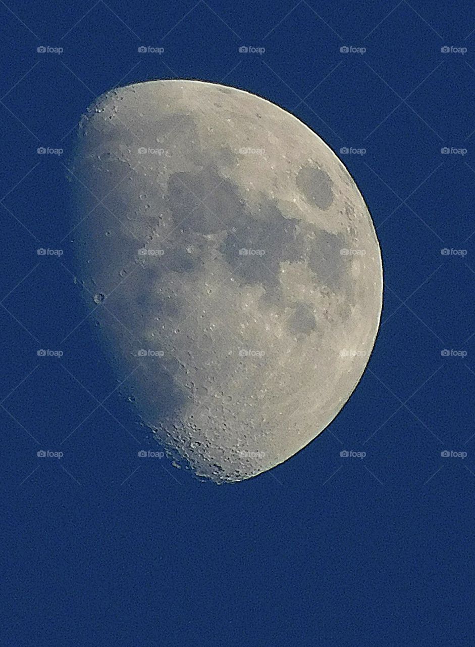 Day and night Foap Missions - Shot of the moon (Waxing Gibbous)during the late afternoon,  proudly displaying the sun spots and the craters on the outer crust, during a blue sky