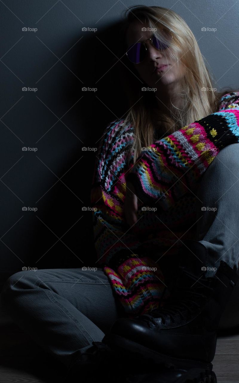 Woman modeling in a vibrant, knitted sweater