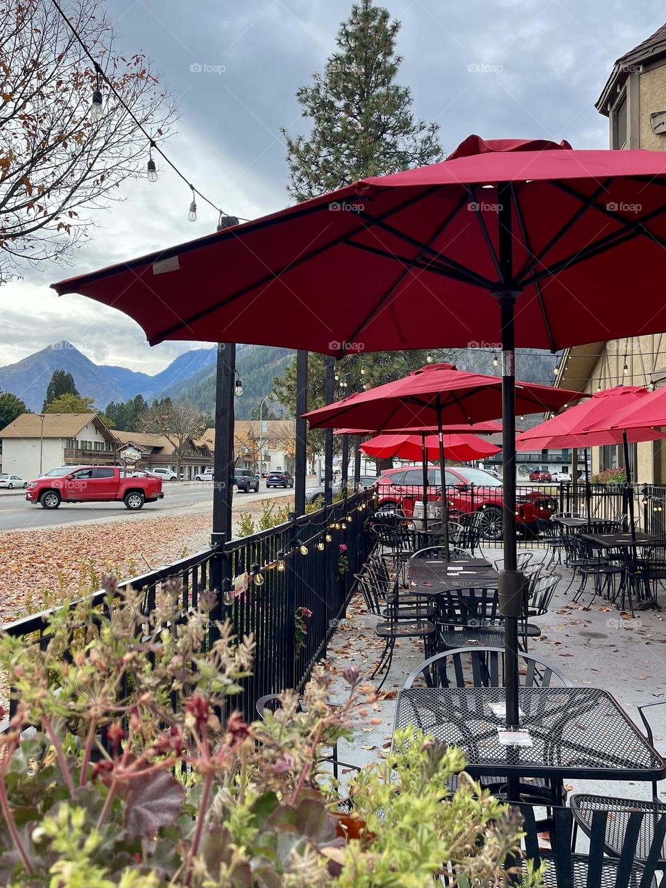 Empty autumn cafe with red umbrellas 