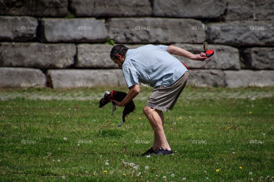 Man is taking care of his tiny pet dog