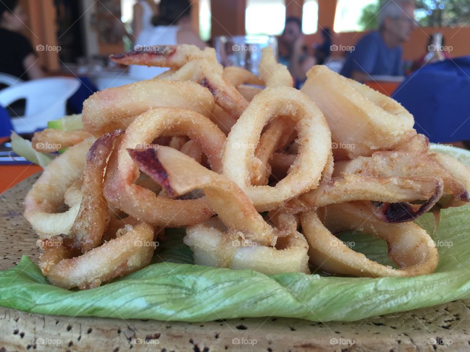 Delicious fried fish mix to take away on the beach 
