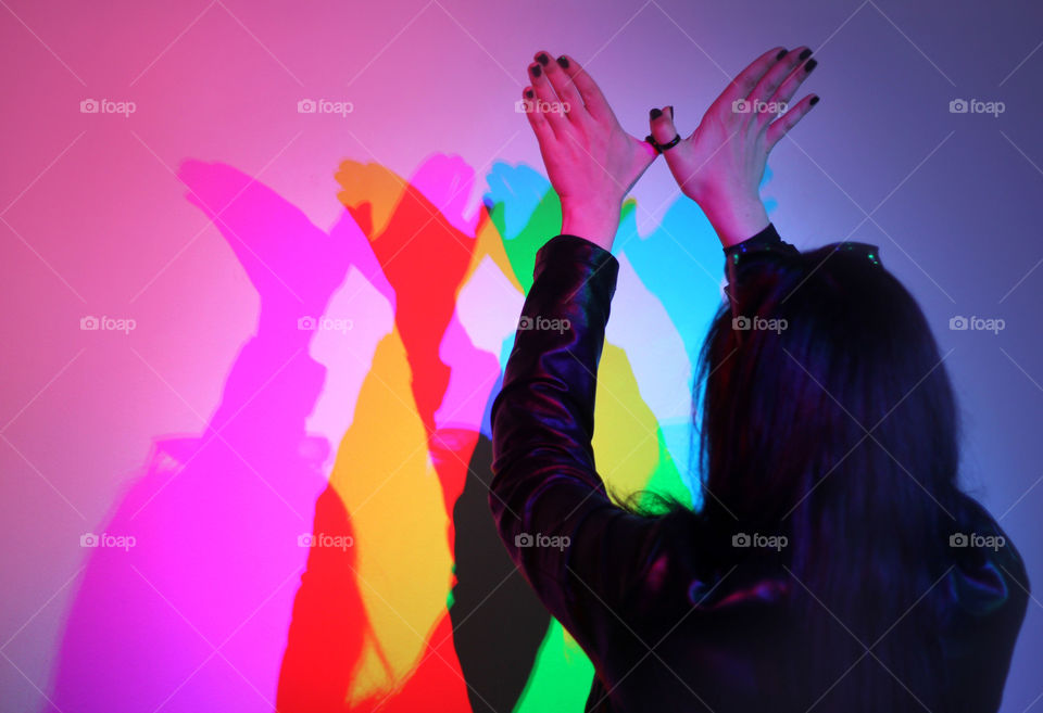 Colorful hands shadows on the wall