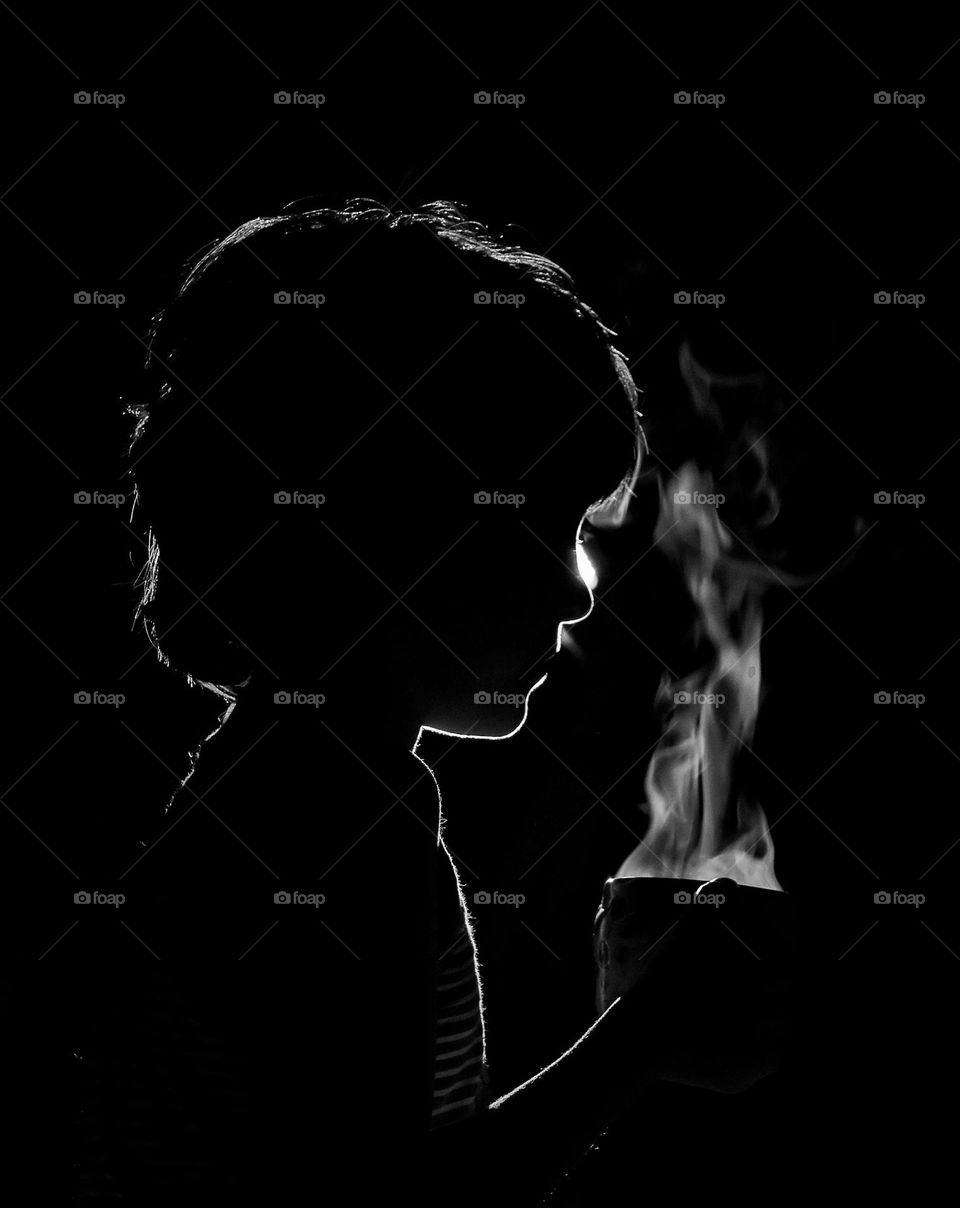 Hot tea in the hands of a child in the dark