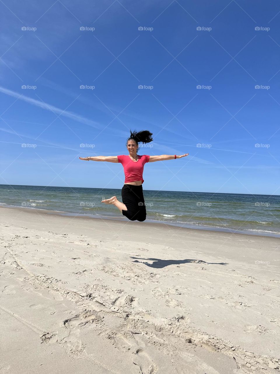 Woman jumping on the beach 