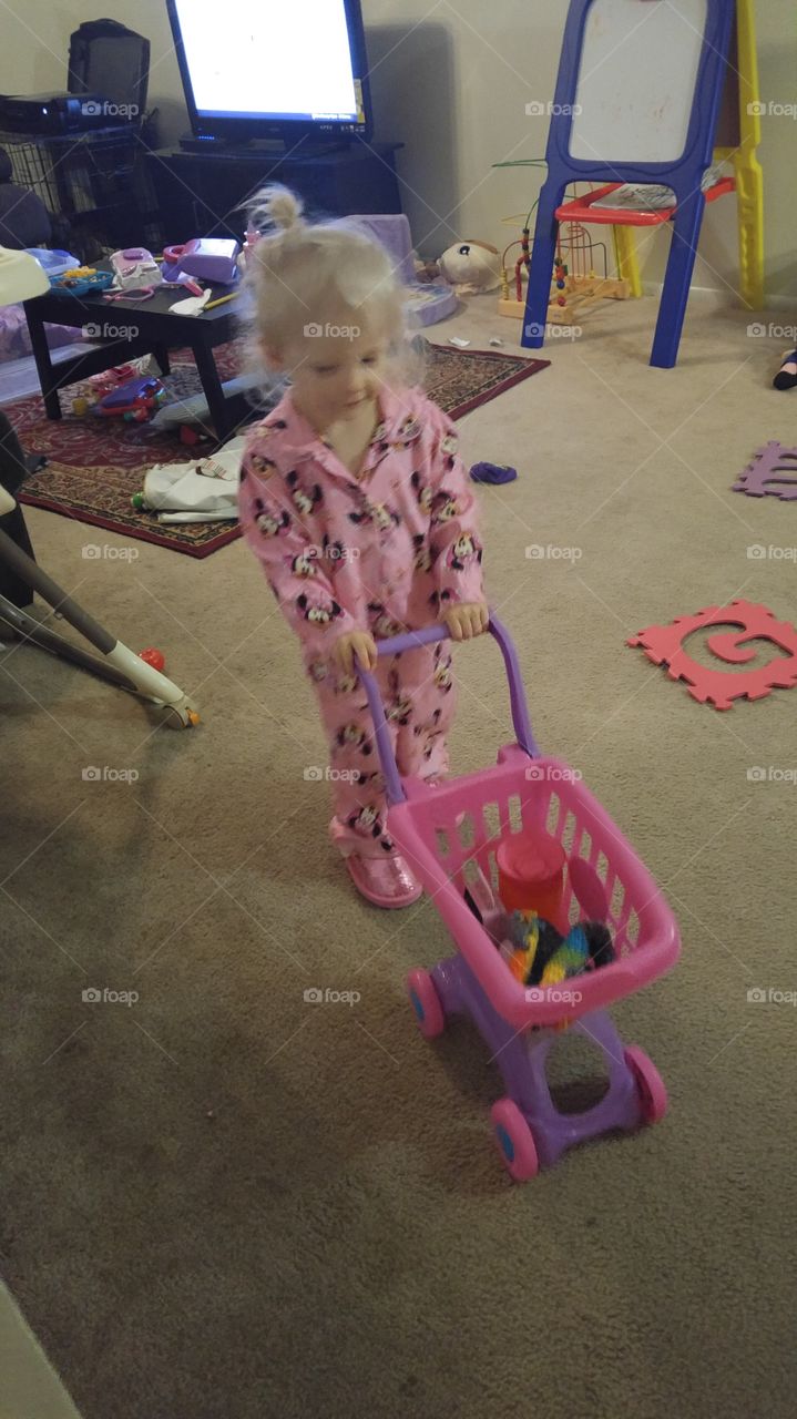 Portrait of a girl playing with cart