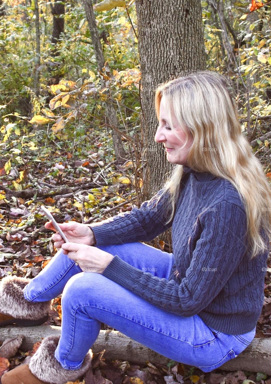 Woman relaxing and using her phone 