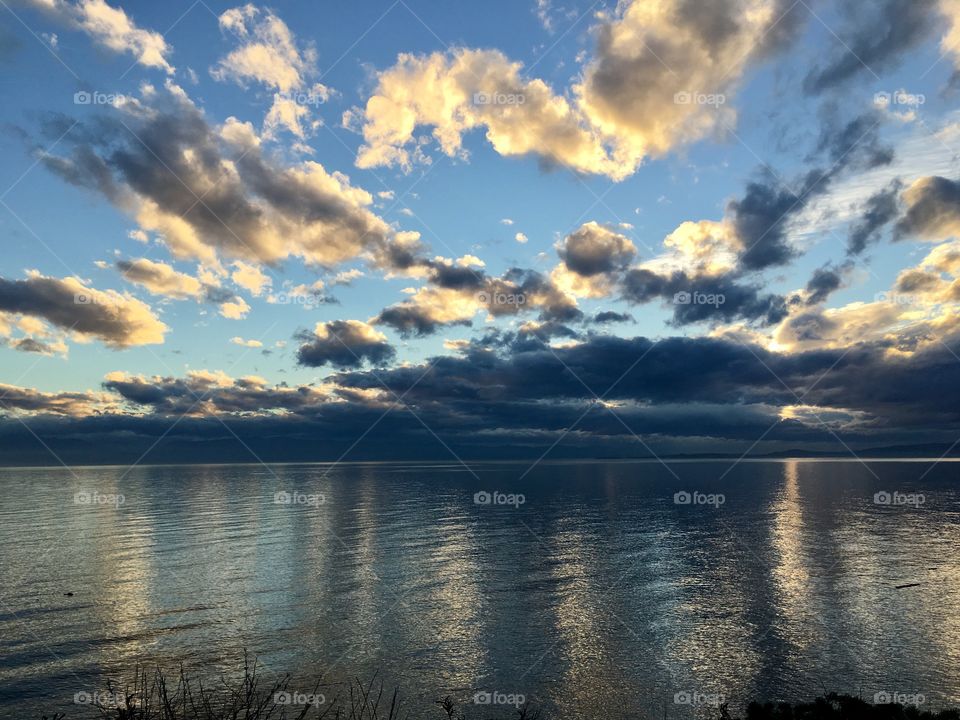 Dramatic sky over sea at sunset