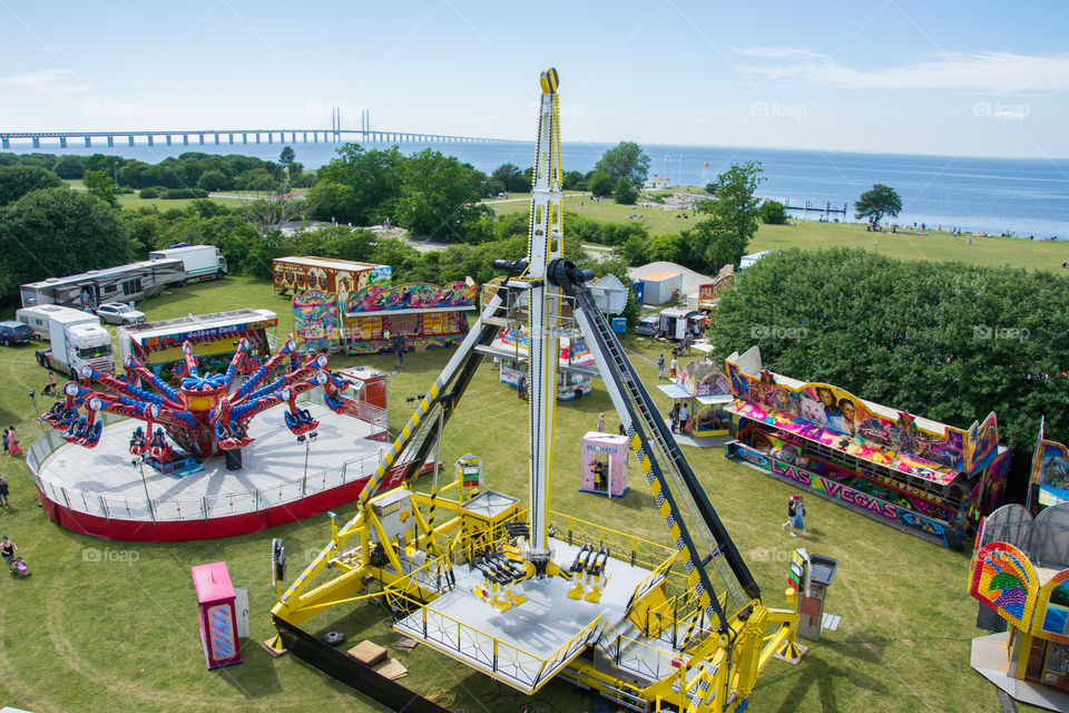 Fun fair in Malmö Sweden with the Öresunds bridge to Denmark in the background.