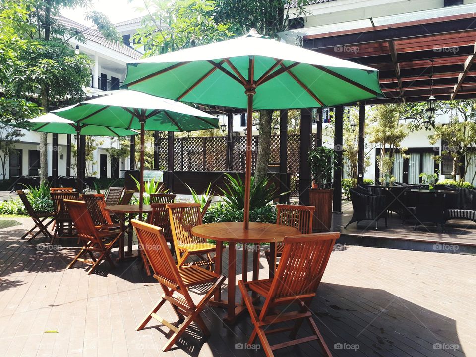green umbrellas used specifically in the pool area