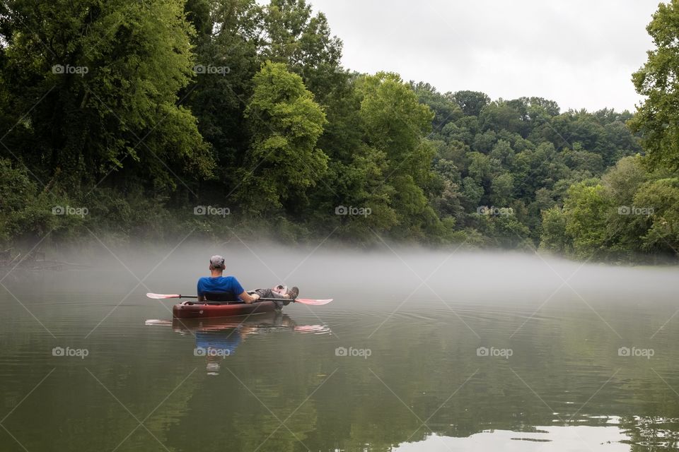 Foap, hobby time. A kayaker relaxing and letting the gentle flow take him down the river. Elk River in Franklin County Tennessee. 