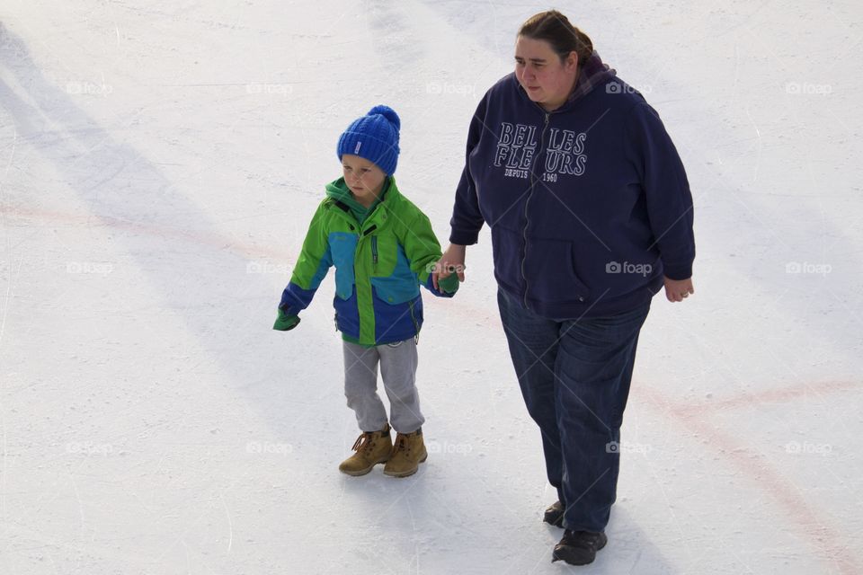 Mom and son on ice rink

