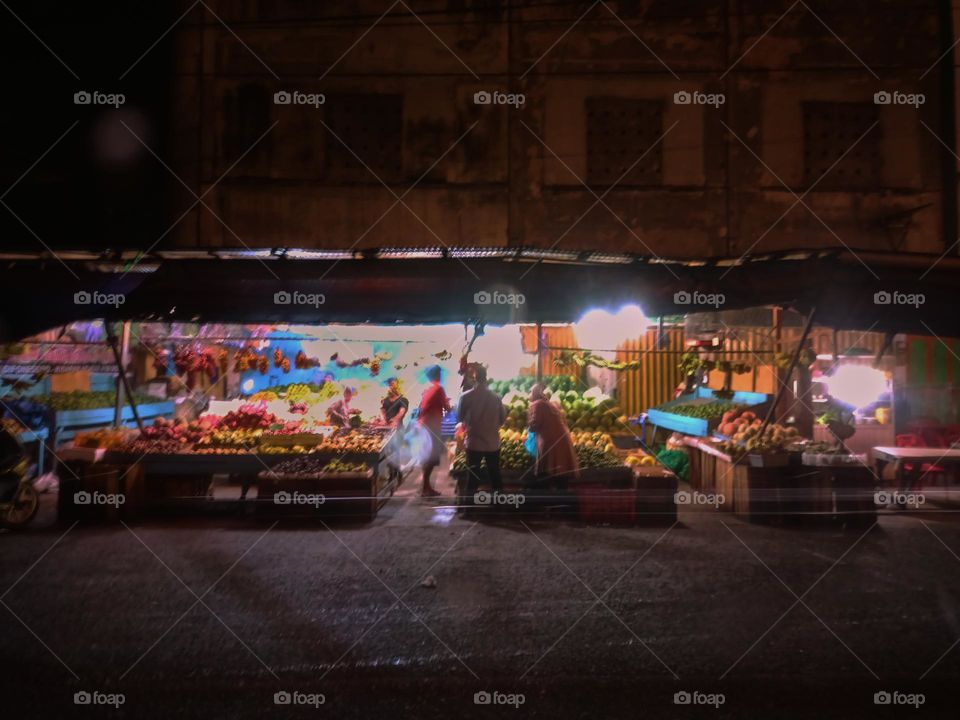 Night view of a traditional store by street. Long exposure, blured and defocused