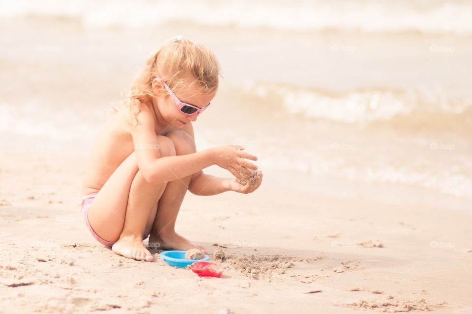 Girl playing in the sand