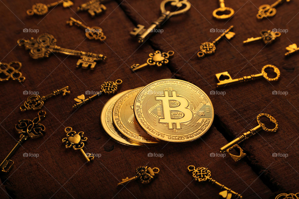Crypto currency Bitcoin physical coin with golden treasure keys