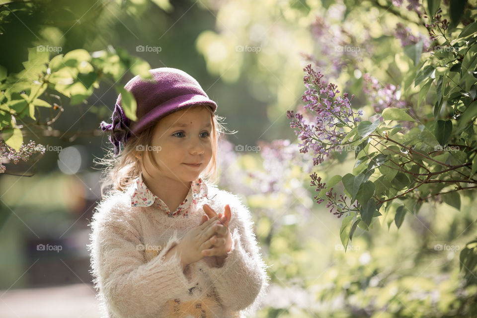 Cute Little girl in a blossom park