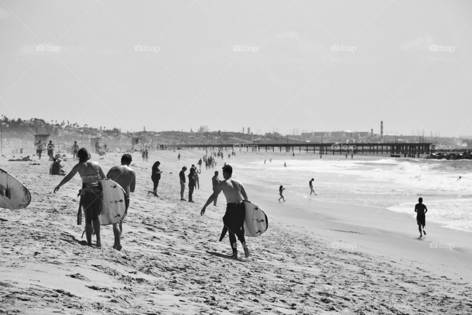 Surfers enjoy the sun and waves in Venice beach , Los Angeles. Pacific Ocean at its best! 