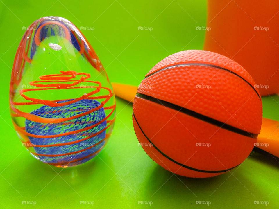 Orange objects and a bright green background.