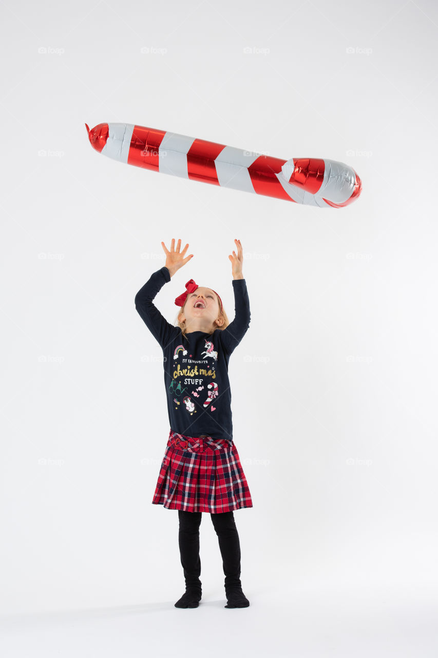 Young girl playing with balloon