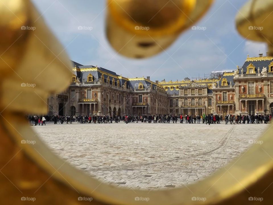 versailles. the palace of versailles in france through the gates