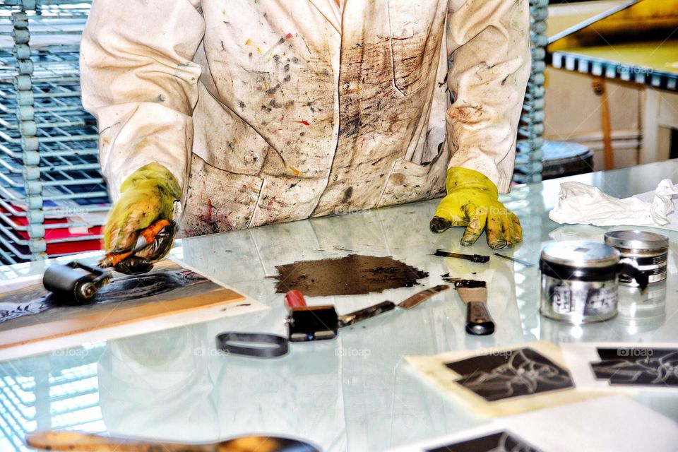 Man making ink block prints