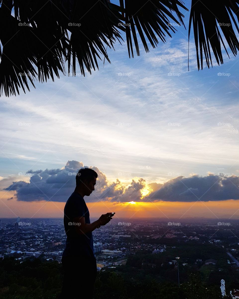 Scenic view of city against sunset sky