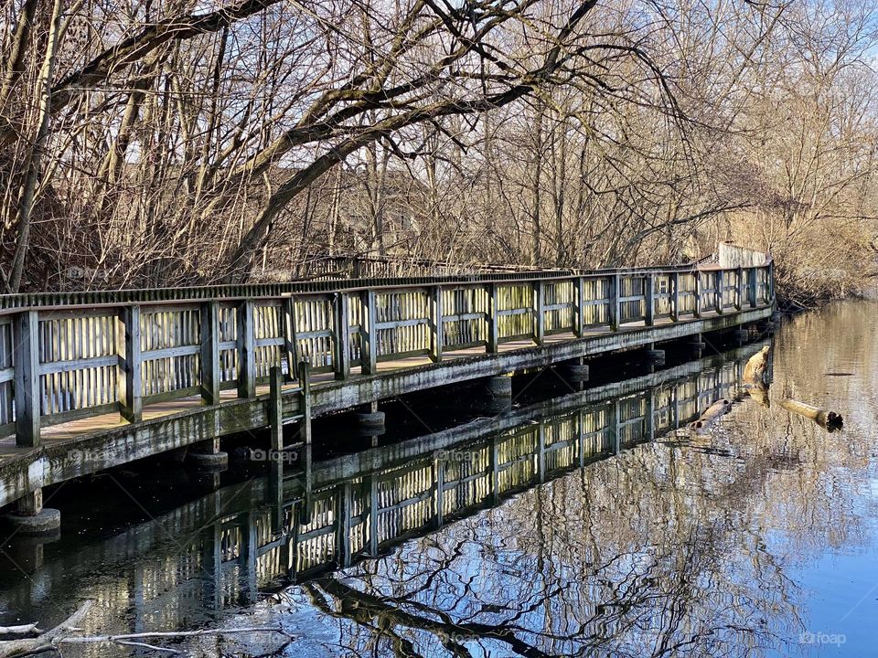A boardwalk around a quarry lake at a local park 