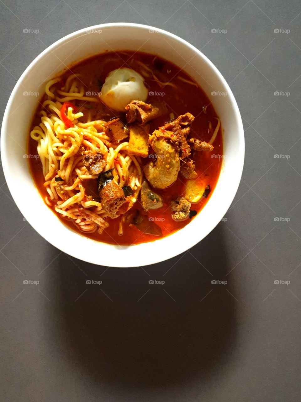 a bowl of asian curry noodle