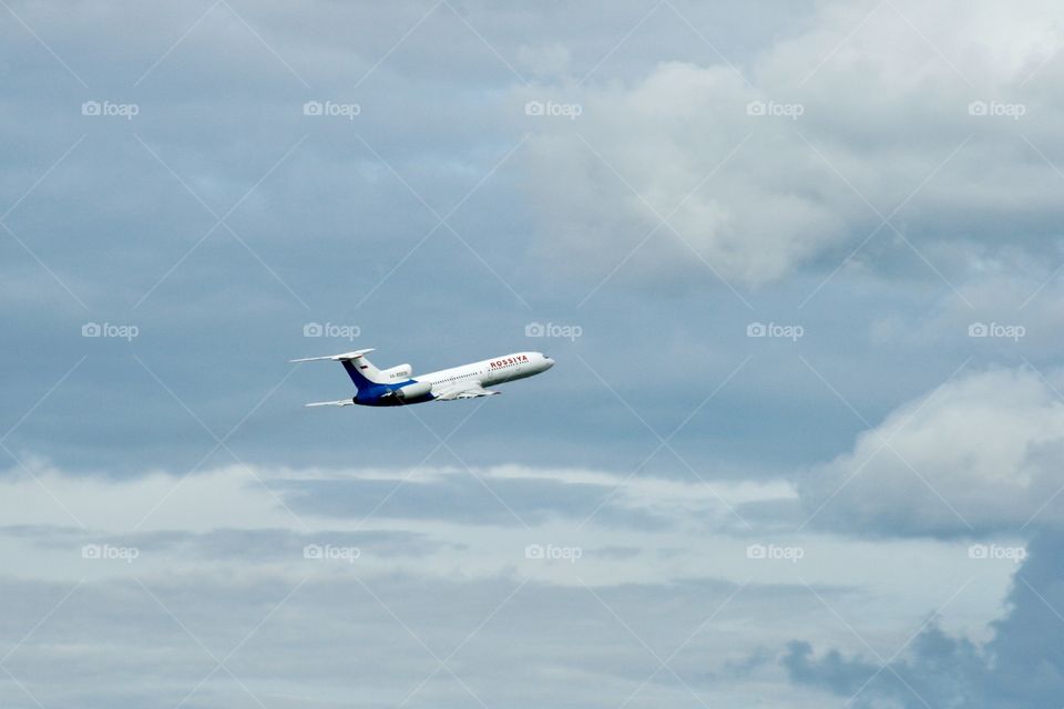 Airplane and cloudy sky 